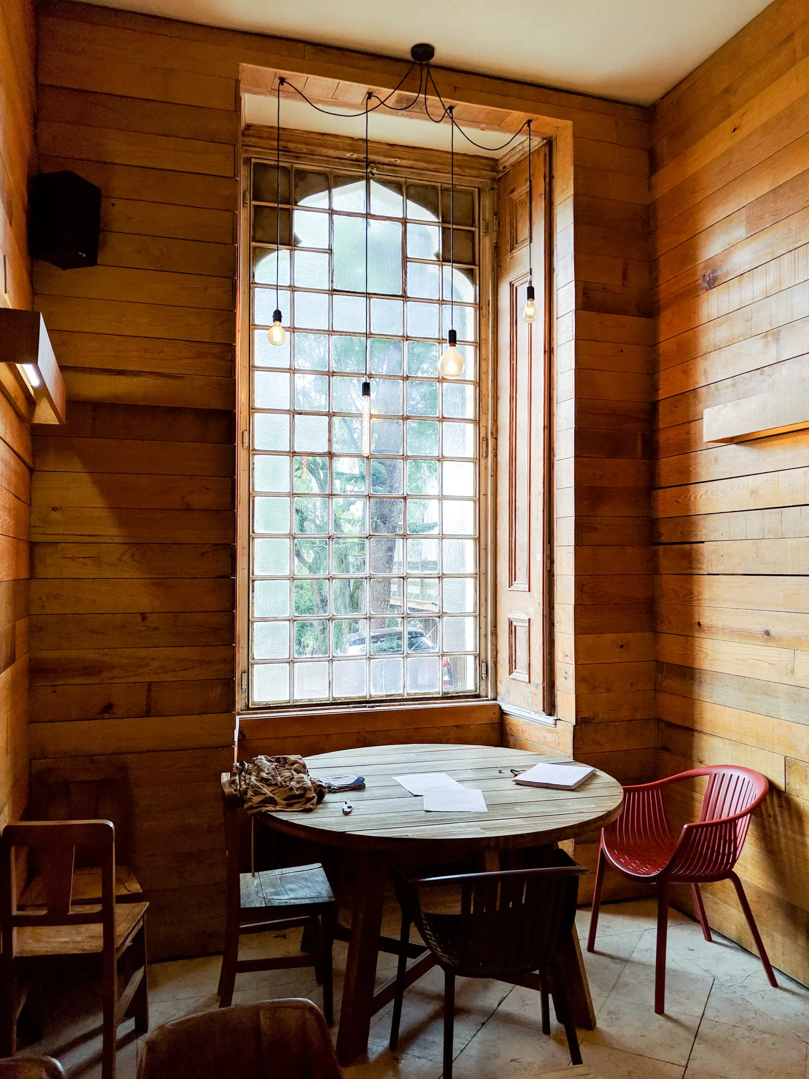 An empty dining room with a shared table and natural light